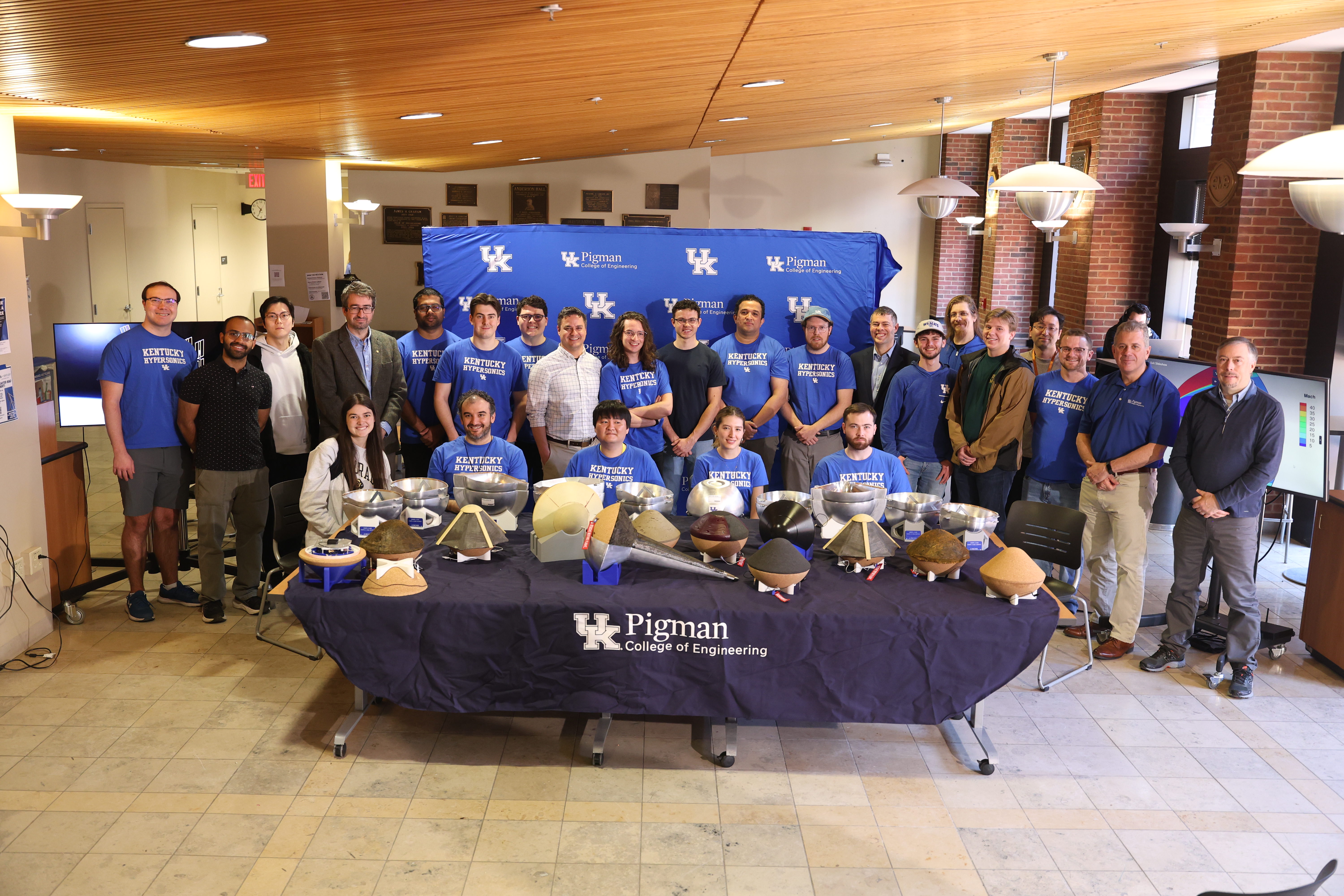 Group of researchers, students, and space capsules